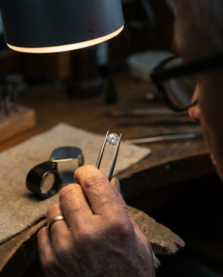 Jeweller inspecting a diamond with tweezers